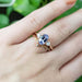 14kt rose gold purple sapphire and lab diamond ring paired with a leaf-accented band on hand