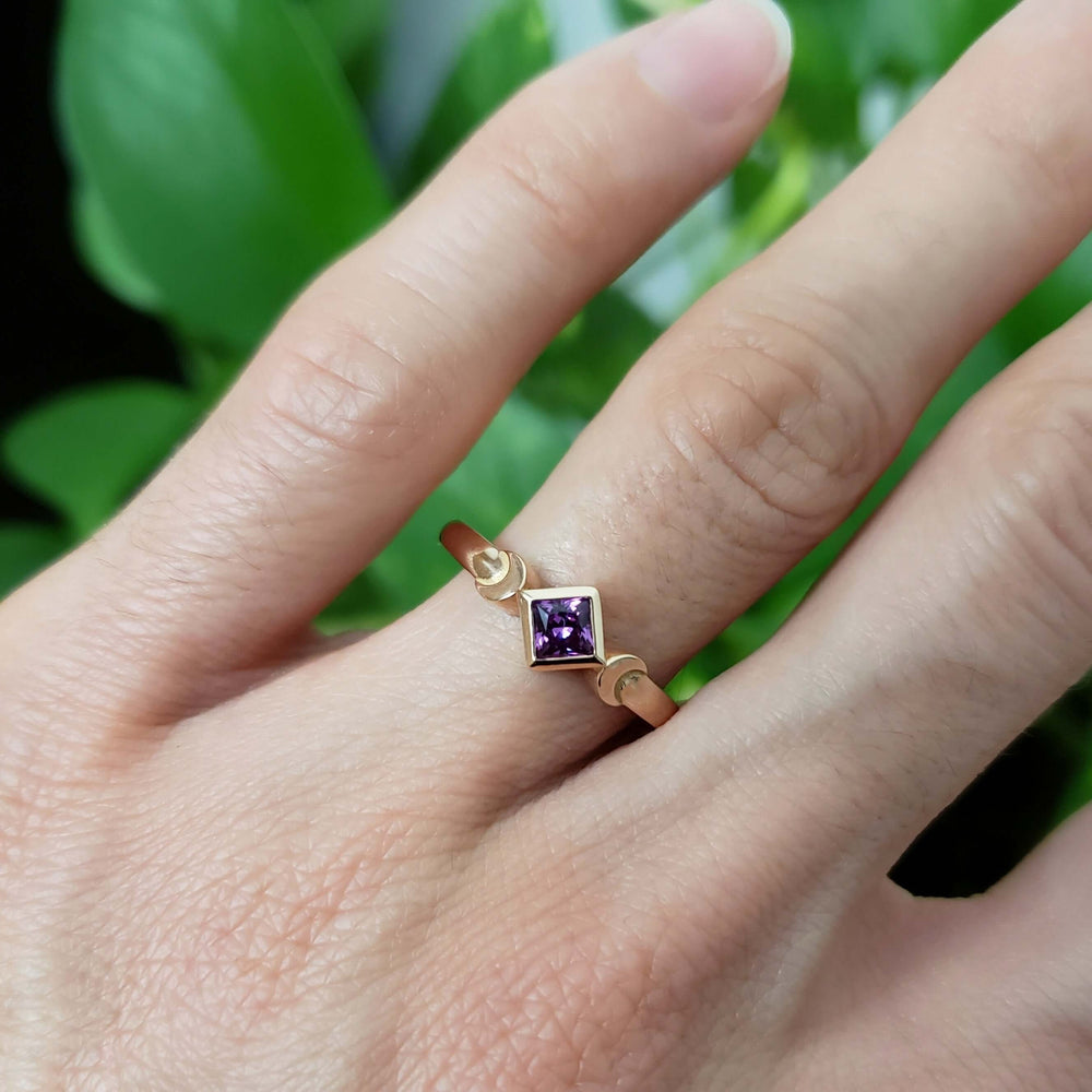 14kt rose gold ring with lab-grown purple sapphire, worn on a hand