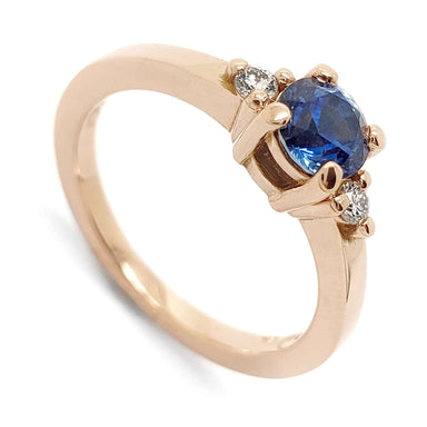 14kt rose gold ring with round blue Montana sapphire and two Canadian diamonds