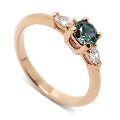 14kt rose gold ring with teal green Montana sapphire and two pear cut lab diamonds