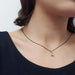 Rose cut moonstone pendant in 14kt rose gold on a black chain, worn at the neck
