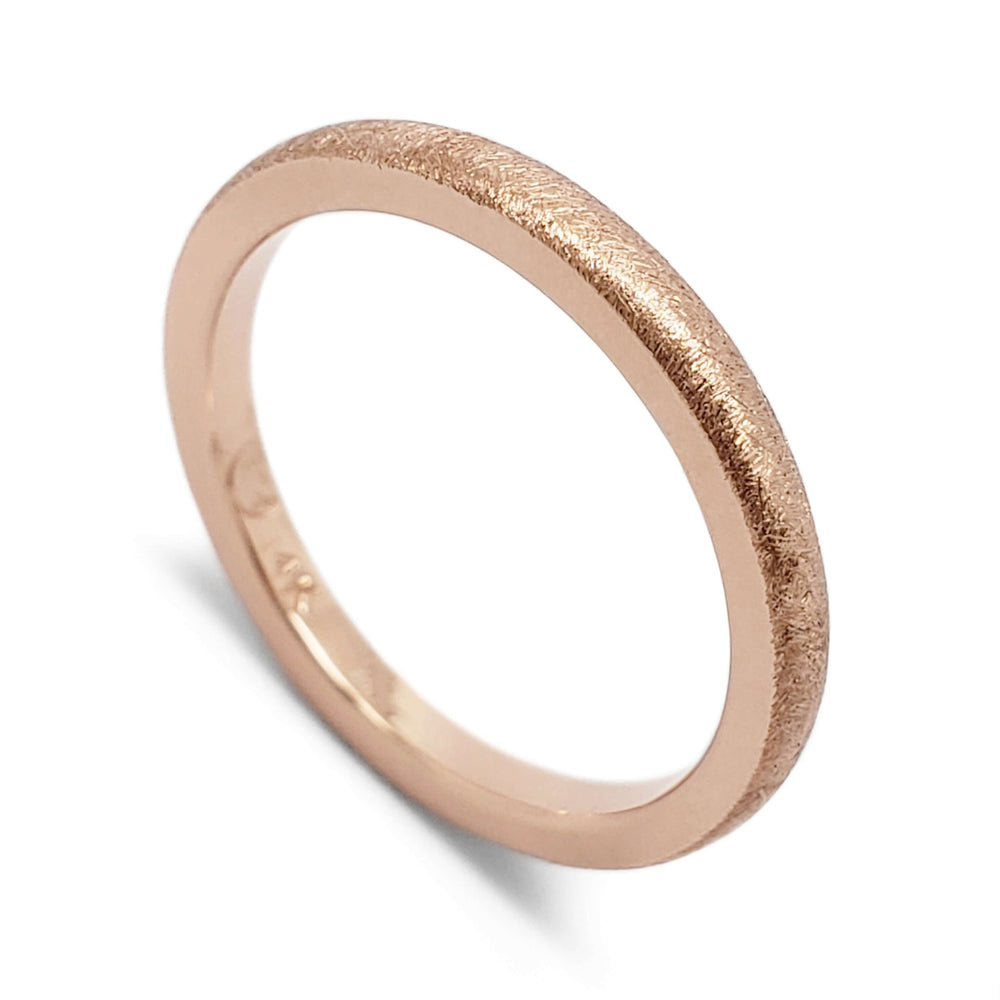 14kt rose gold wedding band with saw blade texture, angled view