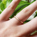 14kt rose gold wedding band with saw blade texture shown on hand