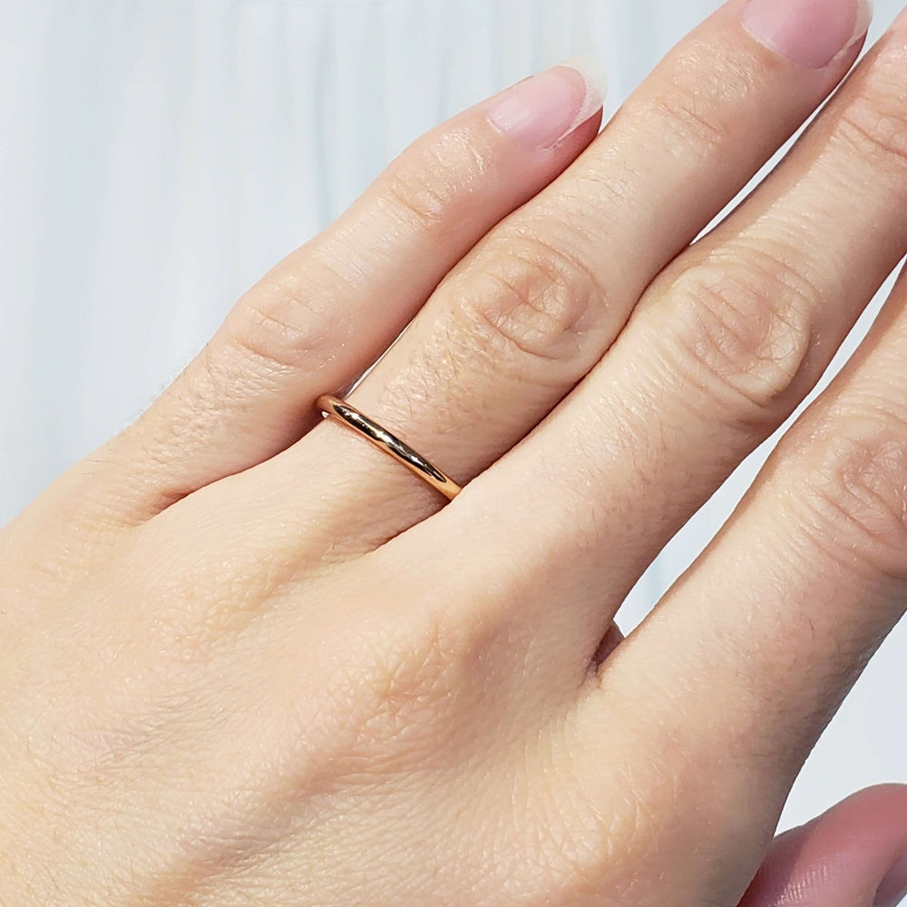 14kt rose gold wedding ring worn on a hand
