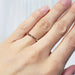 14kt rose gold wedding ring worn on a hand