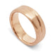 14kt rose gold wedding ring with brushed texture and asymmetrical carved line