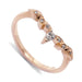 14kt rose gold wedding ring with central pear cut diamond and leaf details