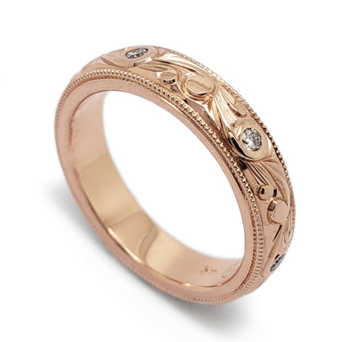 14kt rose gold wedding ring with scroll engraving and Canadian diamonds, angled view