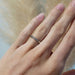 14kt white gold Canadian diamond wedding ring worn on a hand