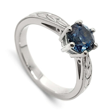 14kt white gold engagement ring with round blue Montana sapphire and engraved wheat band