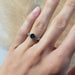 14kt white gold Montana sapphire ring with interlace design shown on hand