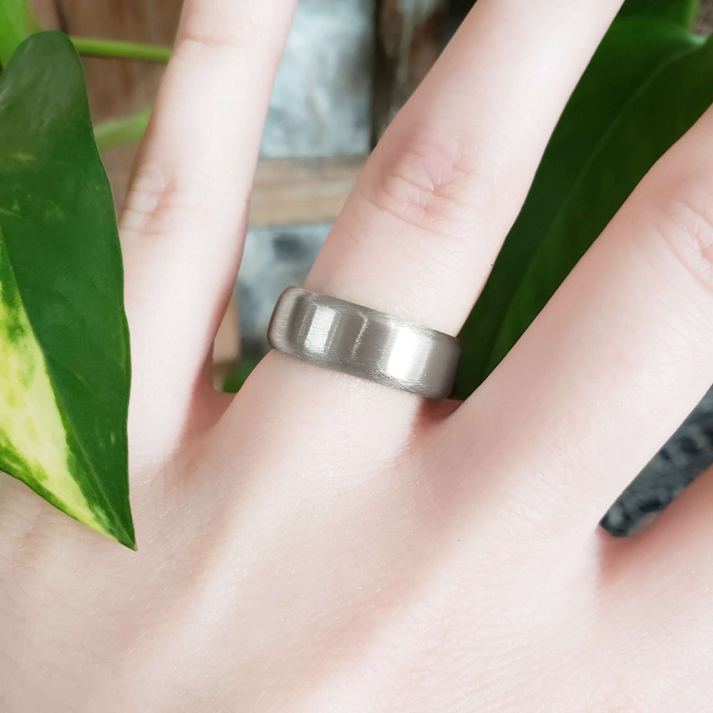 14kt white gold brushed flat wedding band worn on hand