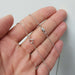 Hand holding a 14kt white gold cable chain showing both spring and lobster clasps