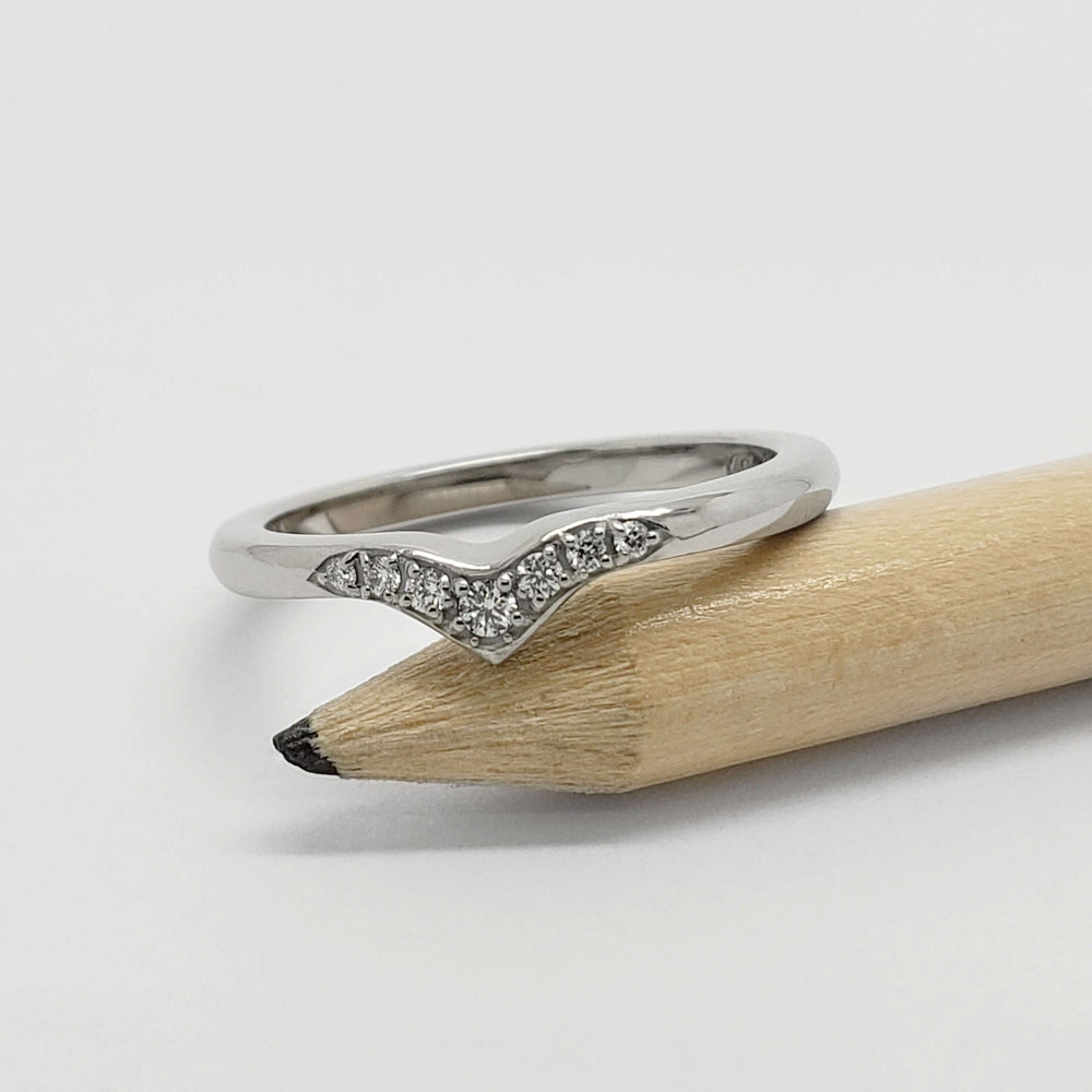 14kt white gold chevron diamond ring displayed on a pencil