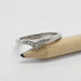 14kt white gold chevron diamond ring displayed on a pencil