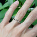 14kt white gold chevron diamond ring with three diamonds, worn on hand