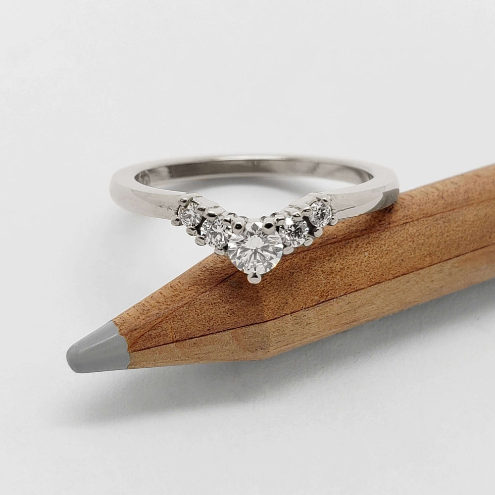 14kt white gold chevron diamond ring displayed on a pencil