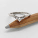 14kt white gold chevron diamond ring displayed on a pencil