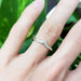 14kt white gold chevron diamond wedding ring worn on a hand