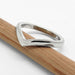 14kt white gold chevron wedding band with millgrain, resting on a pencil