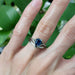 14kt white gold chevron wedding ring stacked with an emerald-cut blue sapphire ring