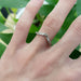 14kt white gold chevron wedding ring with berry engraving worn on a hand