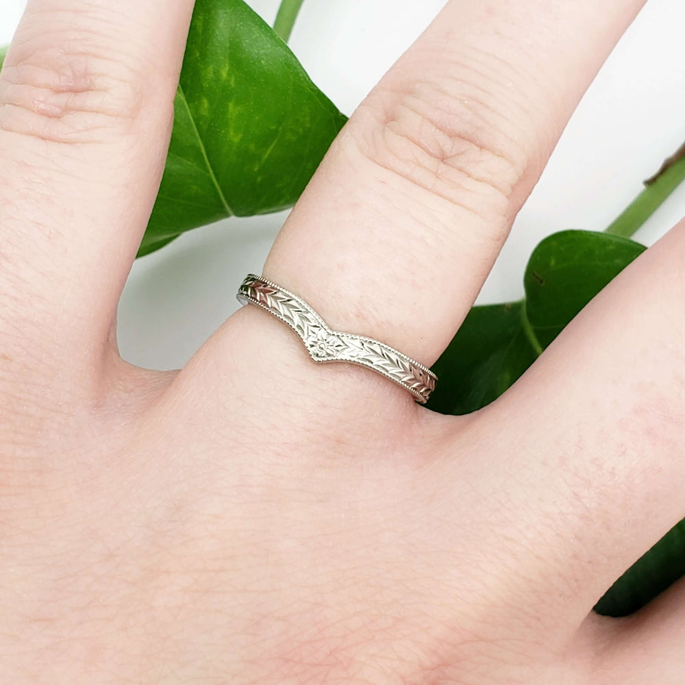 14kt white gold chevron wedding ring with hand engraving, shown on hand