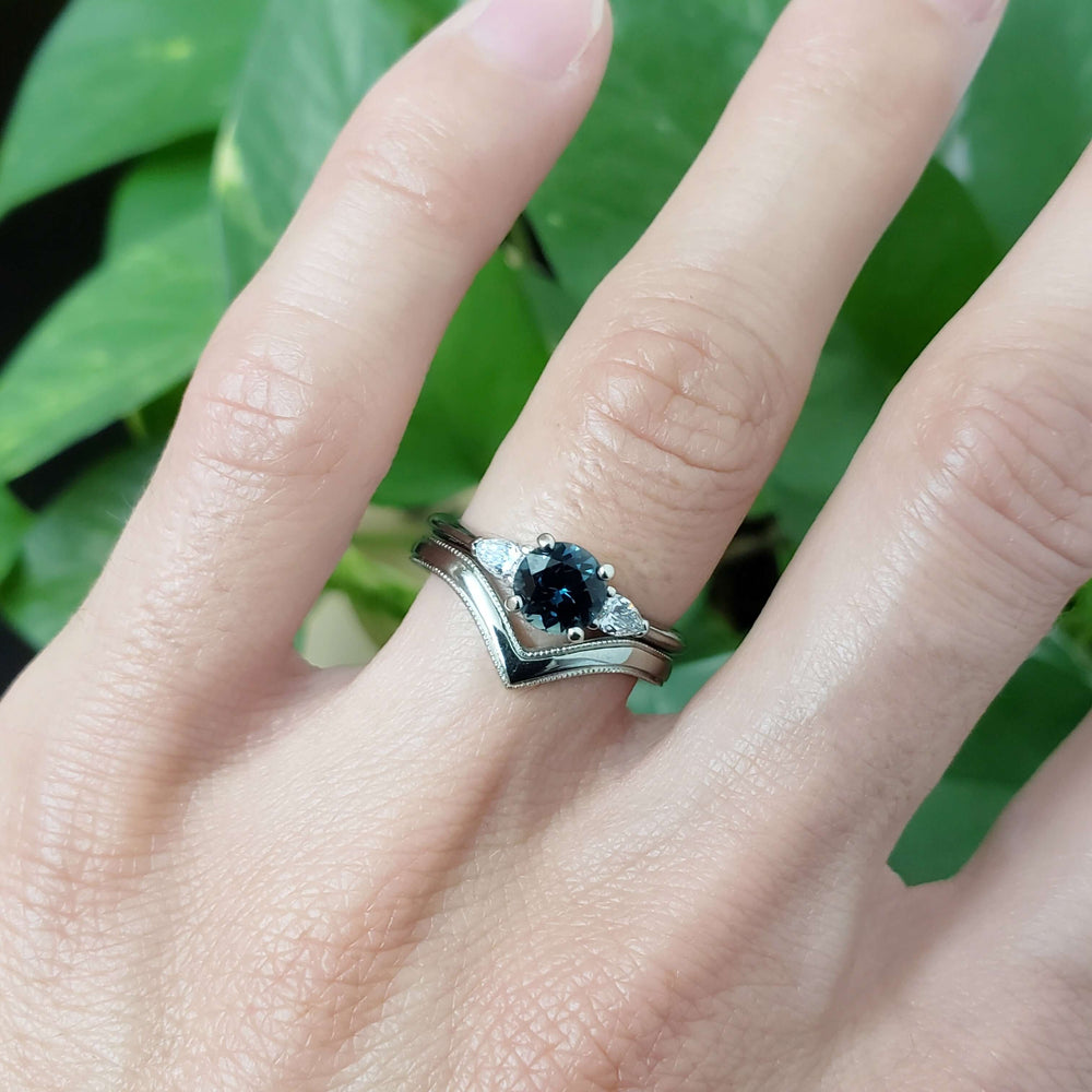 14kt white gold chevron wedding ring with millgrain, paired with sapphire and diamond ring on hand