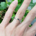 14kt white gold chevron wedding ring with millgrain, shown on a hand