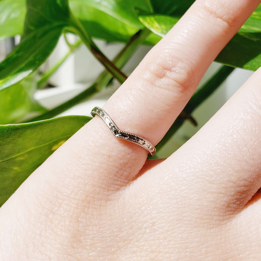 14kt white gold chevron wedding ring with wheat engraving shown on a hand