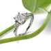 14kt white gold cushion cut lab diamond ring with side stones, shown with green plant