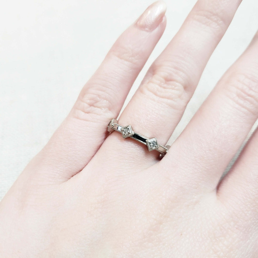 14kt white gold diamond millgrain wedding band worn on a hand