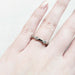 14kt white gold diamond millgrain wedding band worn on a hand