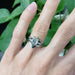14kt white gold emerald cut lab diamond engagement ring stacked with two wedding bands, on hand