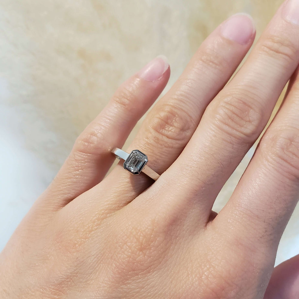 14kt white gold emerald cut lab diamond ring shown on hand