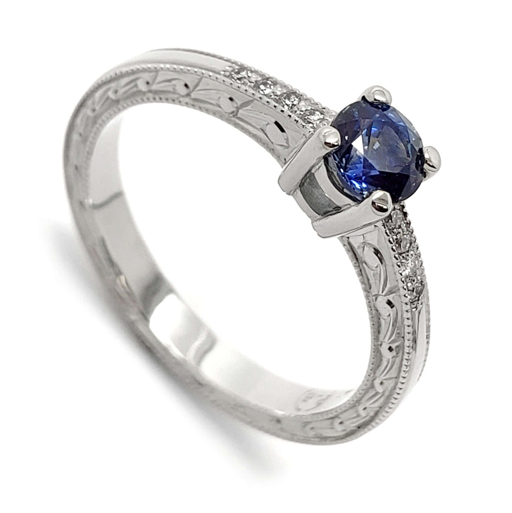 14kt white gold engagement ring with blue Montana sapphire and diamond accents, engraved band