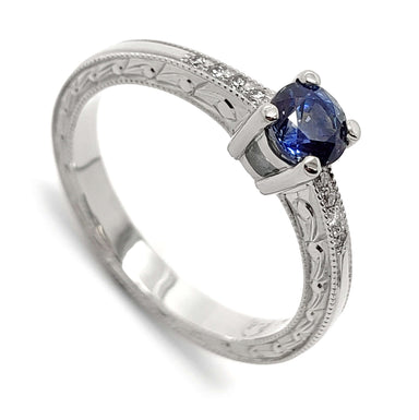 14kt white gold engagement ring with blue Montana sapphire and diamond accents, engraved band