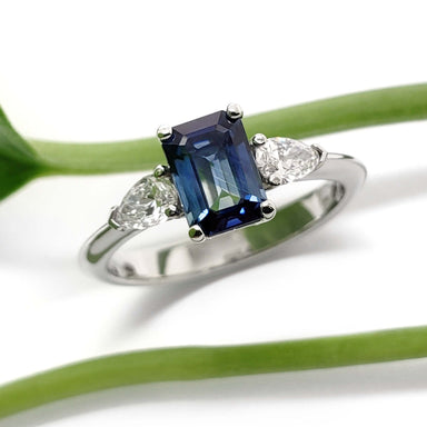 14kt white gold engagement ring with blue emerald cut sapphire and pear shaped diamonds, front view