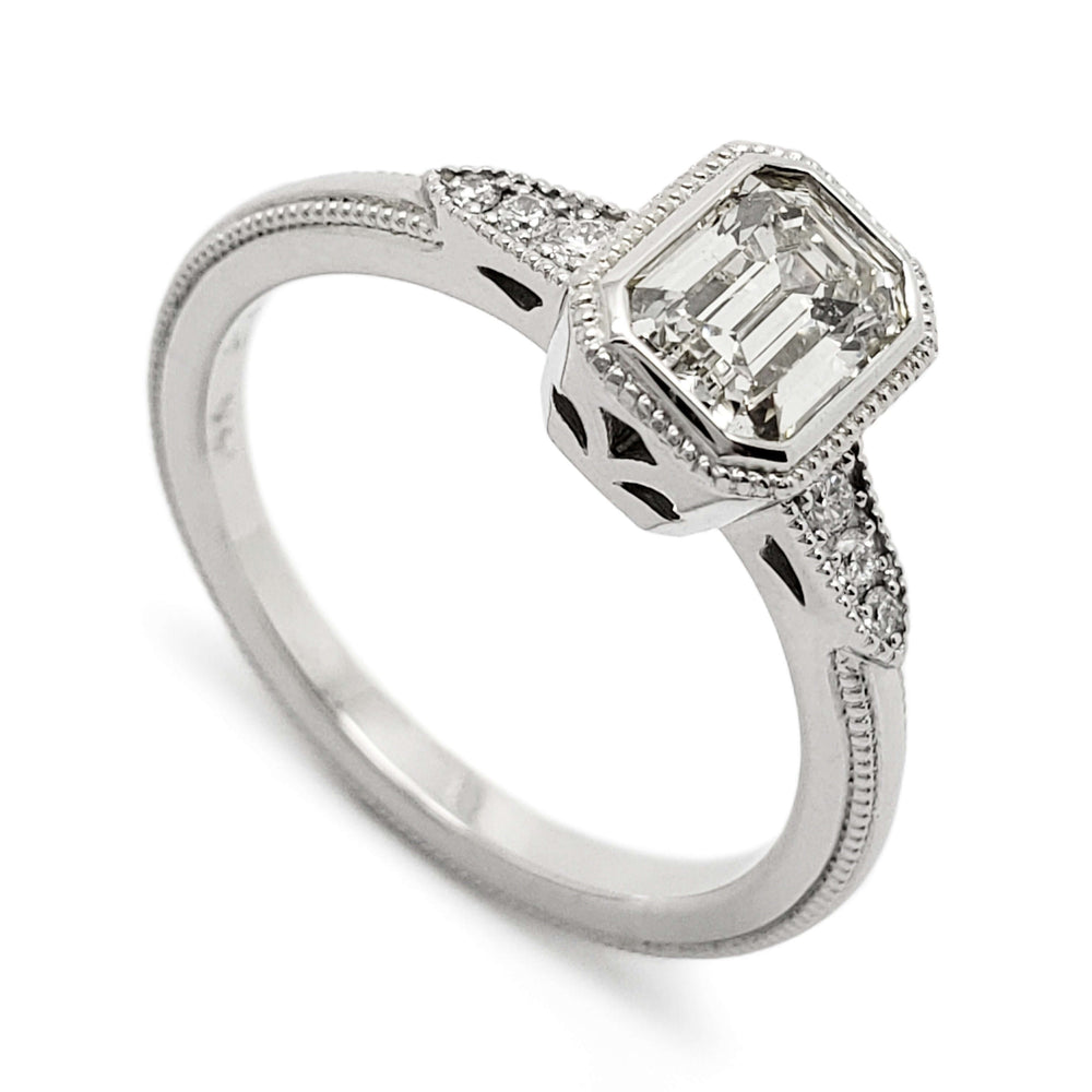 14kt white gold engagement ring with emerald cut lab diamond and side diamonds, millgrain detail