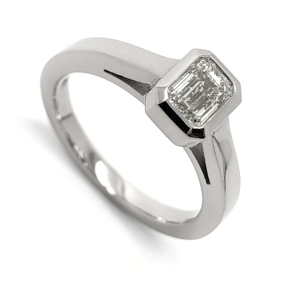 14kt white gold engagement ring with emerald cut lab diamond in bezel setting