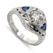 14kt white gold engagement ring with round lab diamond and trillion blue sapphires, engraved and millgrain details
