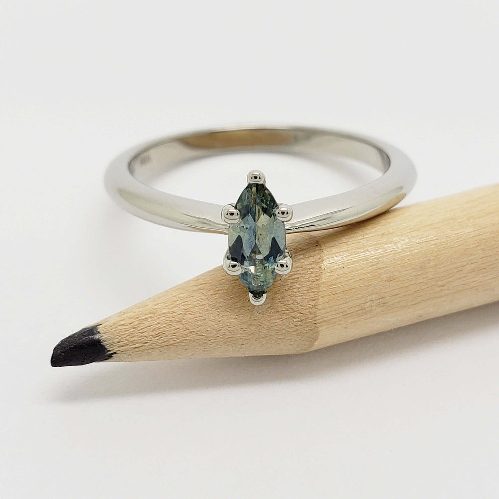 14kt white gold engagement ring with marquise blue-green Montana sapphire on pencil