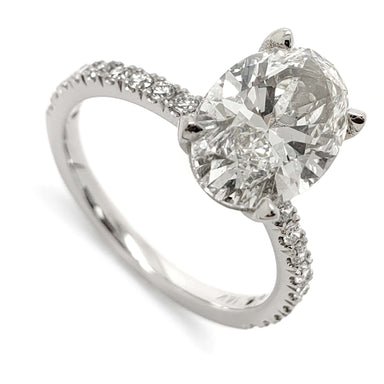 14kt white gold engagement ring with oval lab grown diamond and French pave band