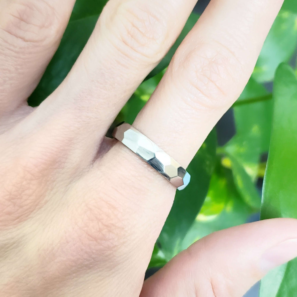 14kt white gold faceted wedding ring shown on hand