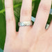 14kt white gold hammered wedding ring shown on a hand