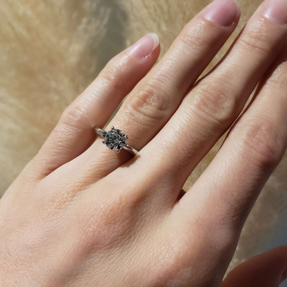 14kt white gold lab diamond engagement ring shown on hand in natural light