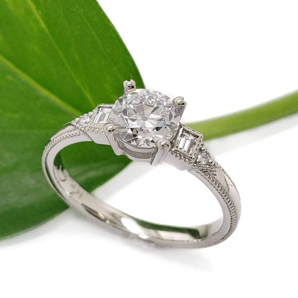 14kt white gold lab diamond engagement ring with vintage detailing, shown beside a green leaf