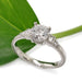14kt white gold lab diamond engagement ring with vintage detailing, shown beside a green leaf