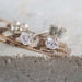 Close-up of 14kt white gold lab diamond stud earrings on a textured surface