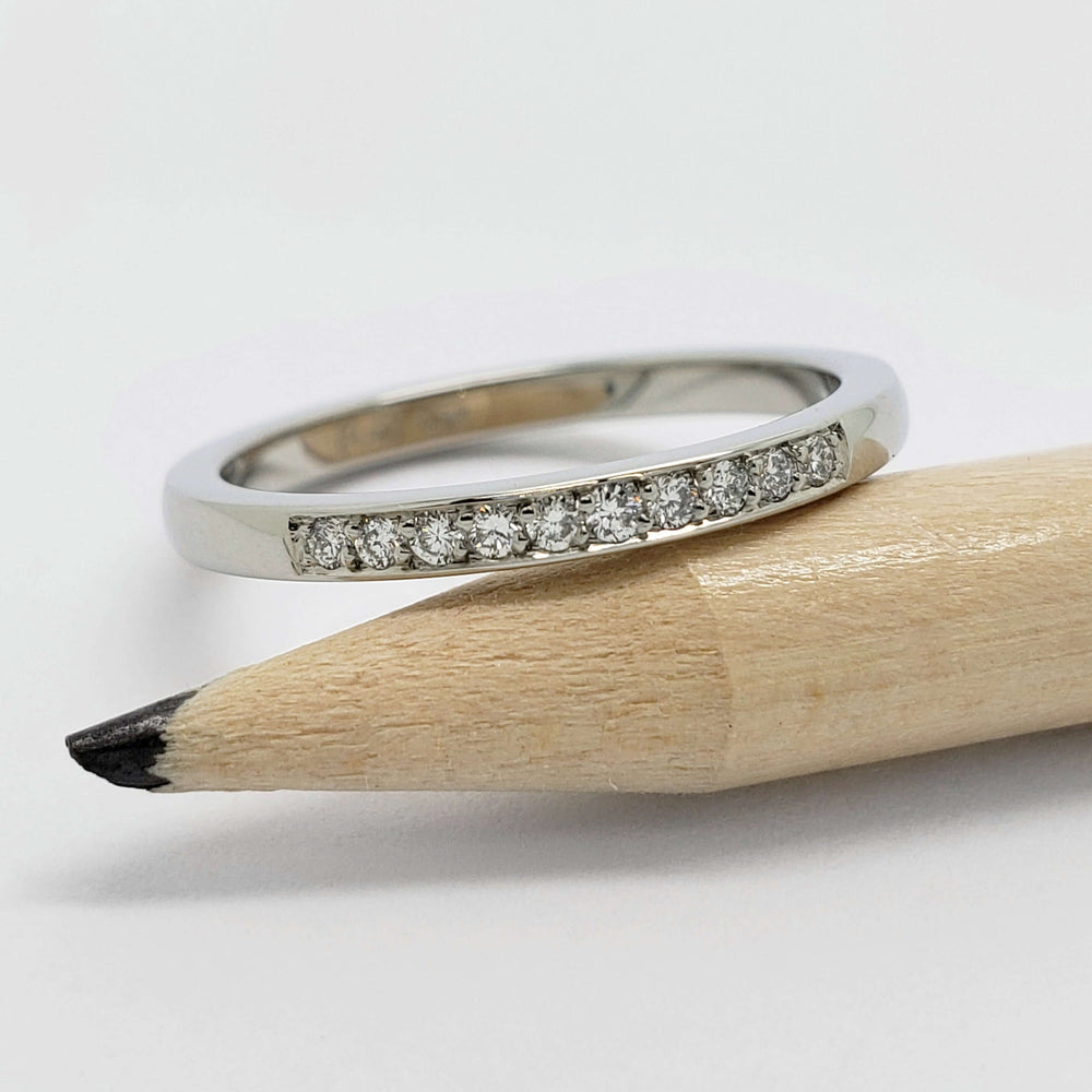 14kt white gold lab diamond wedding ring shown with pencil for scale